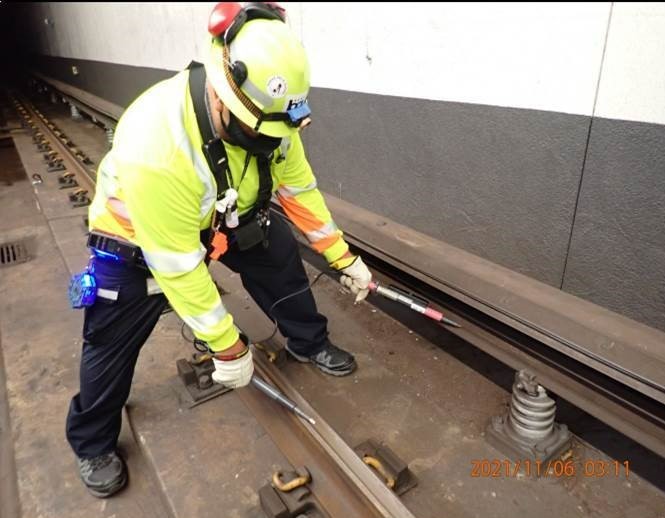 Staff verifying that the third rail is turned off