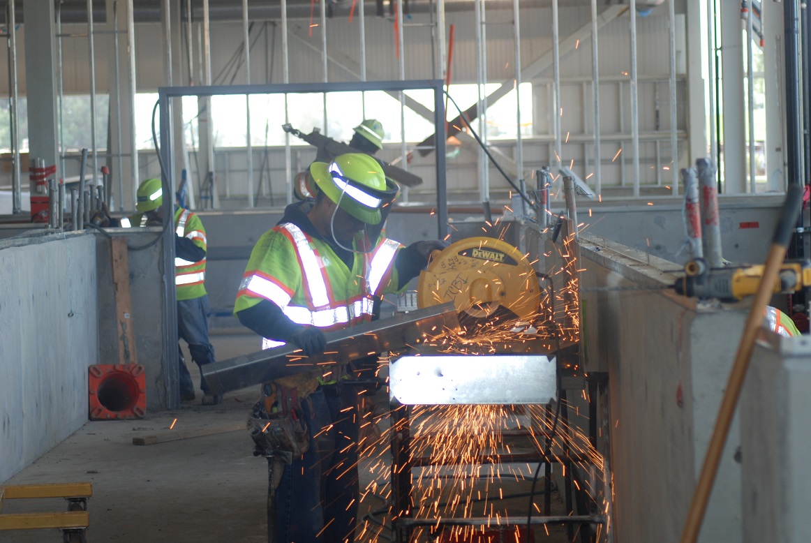A worker uses a saw at a BART construction project
