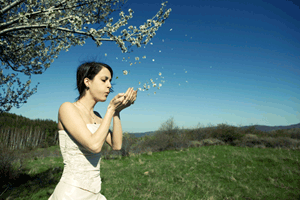 woman blowing leaves