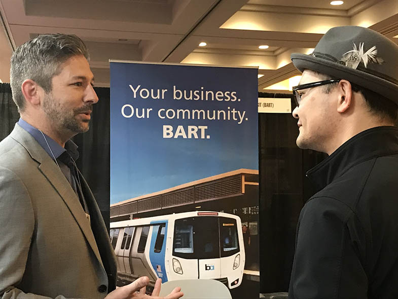 , Liu, in hat, meets one-on-one with a networking attendee at a pre-Covid event in March 2019. Photo by Melissa Jordan
