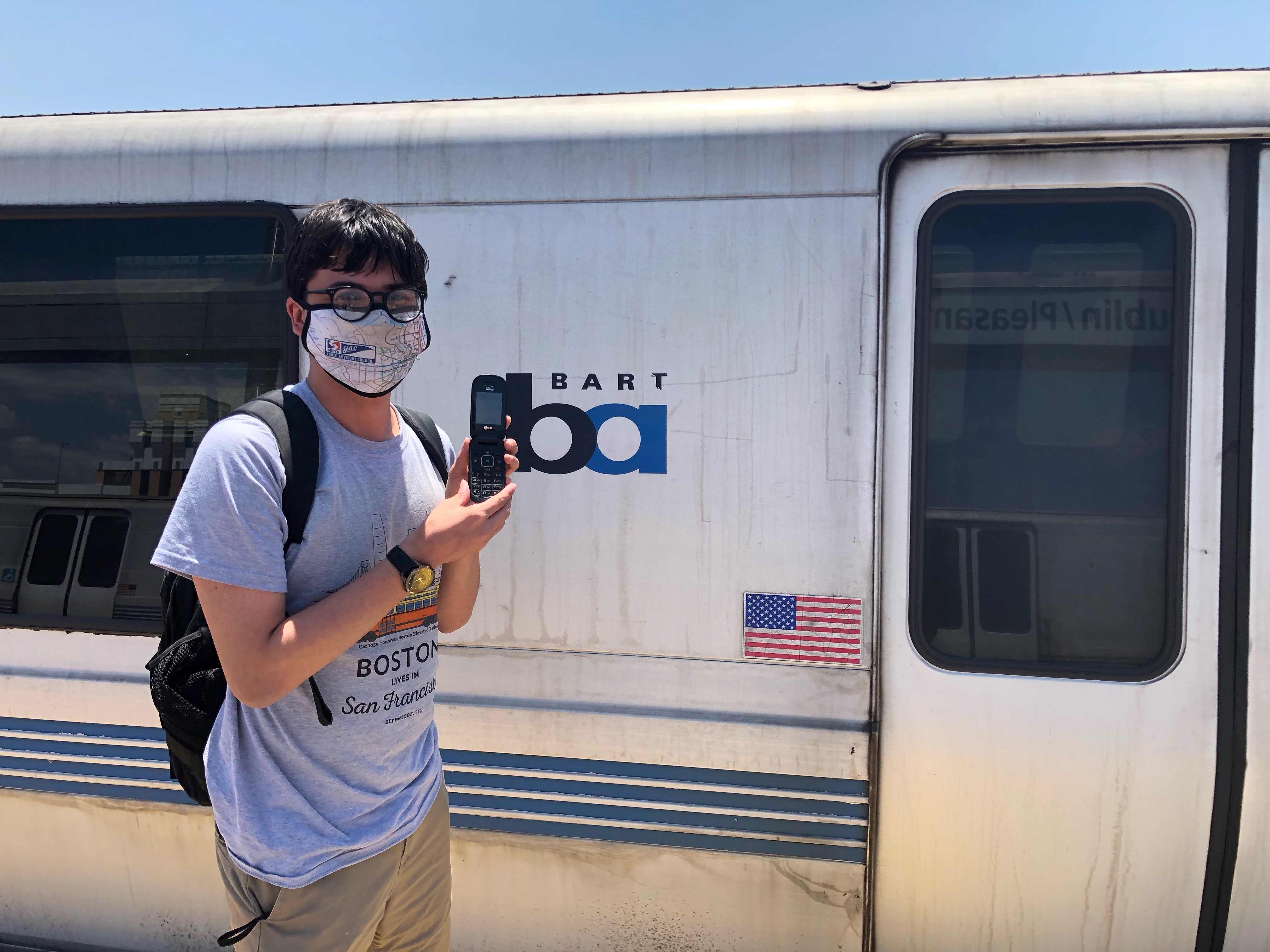 Miles Taylor poses in front of a BART train after completing his speed ru