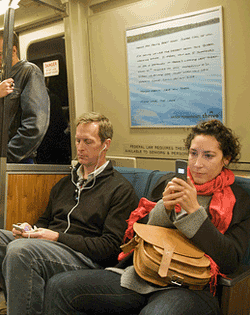 BART riders check their mobile devices on election night 2008