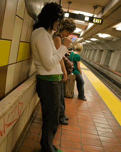 woman in BART station using iPhone