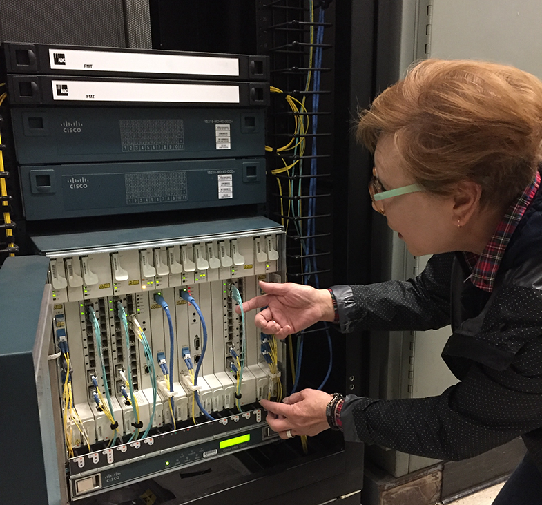 Senior Computer Systems Engineer Julia Quittman inspects part of the Unified Optical Network