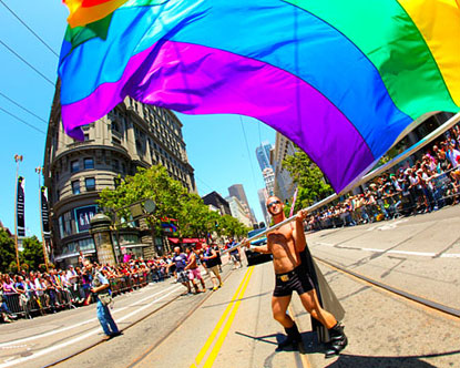 A man waves a flag at SF Pride