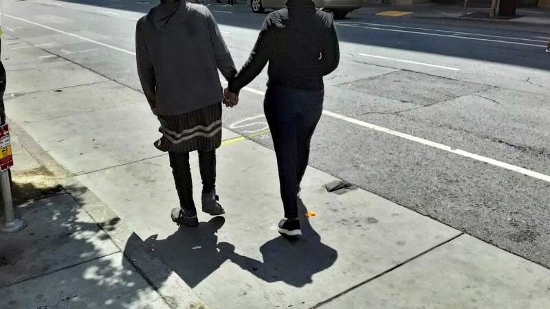 Perry and her son hold hands as they walk together after being reunited in San Francisco