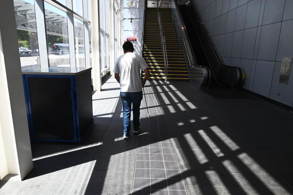 BART intern Erik Huizar studies the tactile guideway at Union City Station on Wednesday, Sept. 6, 2023.
