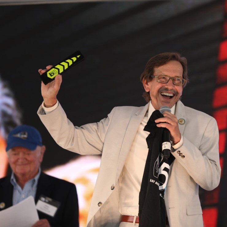 BART Director Robert Raburn places a bike pant strap in the new time capsule at BART’s 50th Anniversary Celebration and Family Fun Festival.