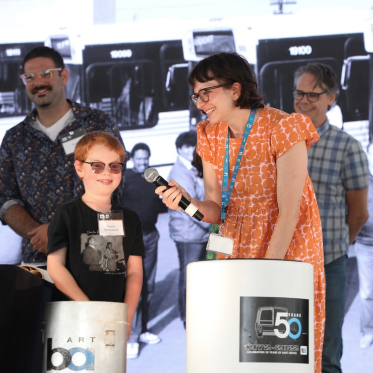 BART fan Charlie pulls an item from the 1992 time capsule onstage during BART’s 50th Anniversary Celebration and Family Fun Festival.