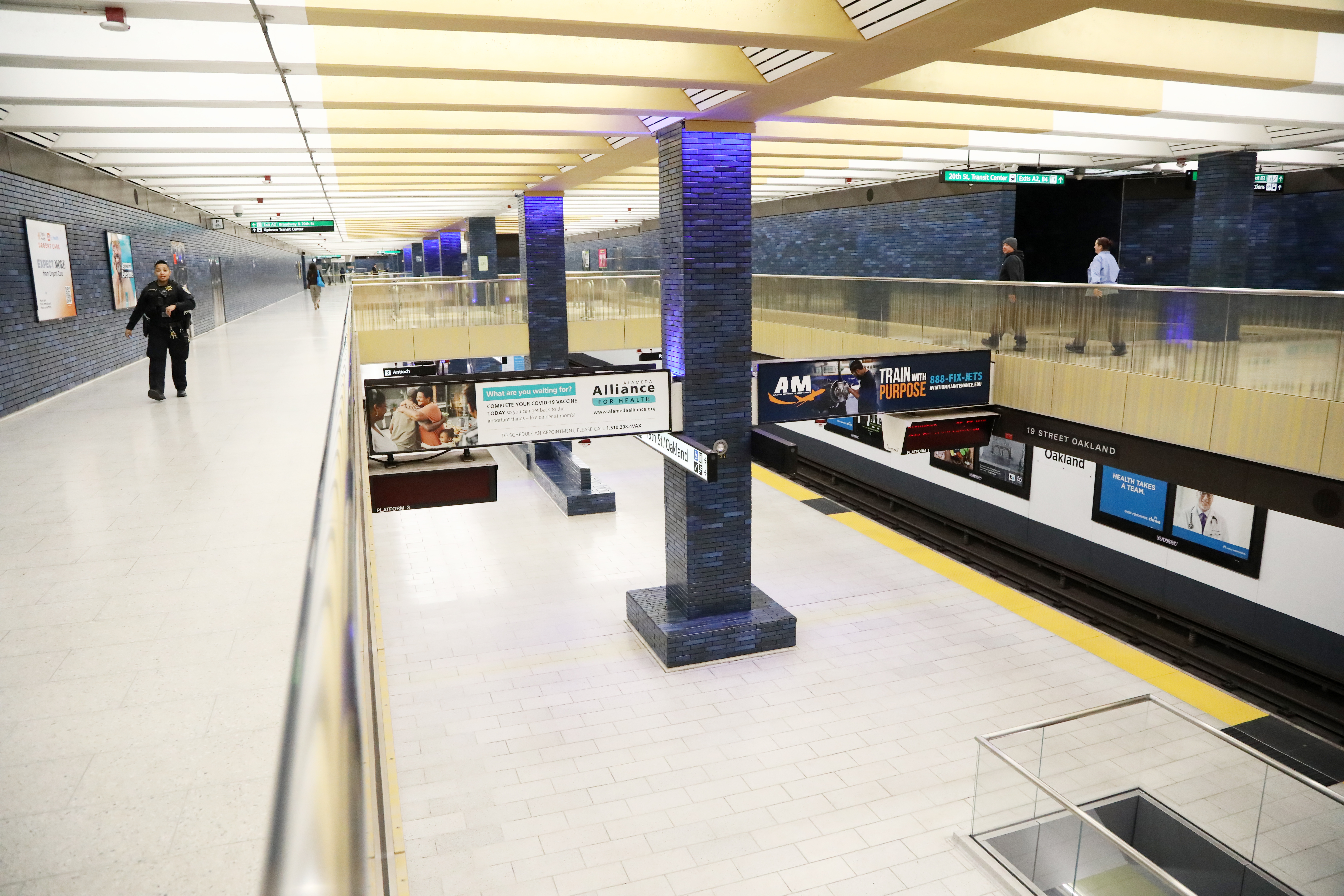 The brightly lit concourse and platform at 19th St Station