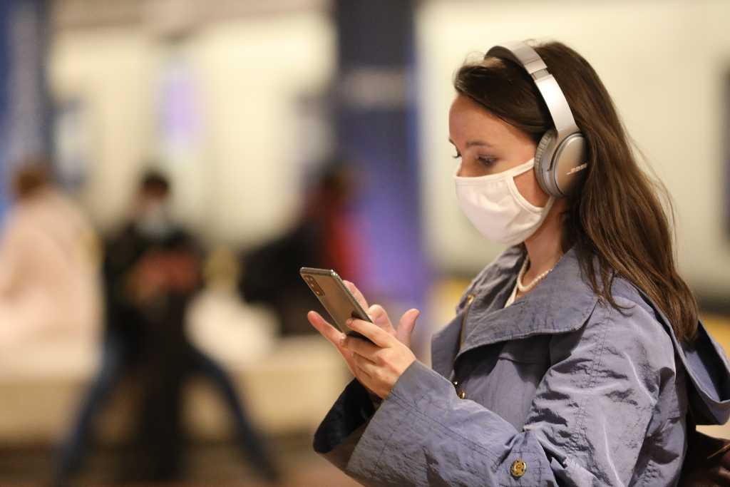 Rider in a BART station with a phone