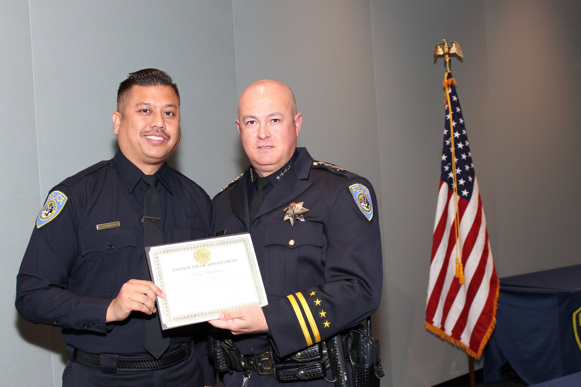 Interim Chief Ed Alvarez poses with sworn-in police officer