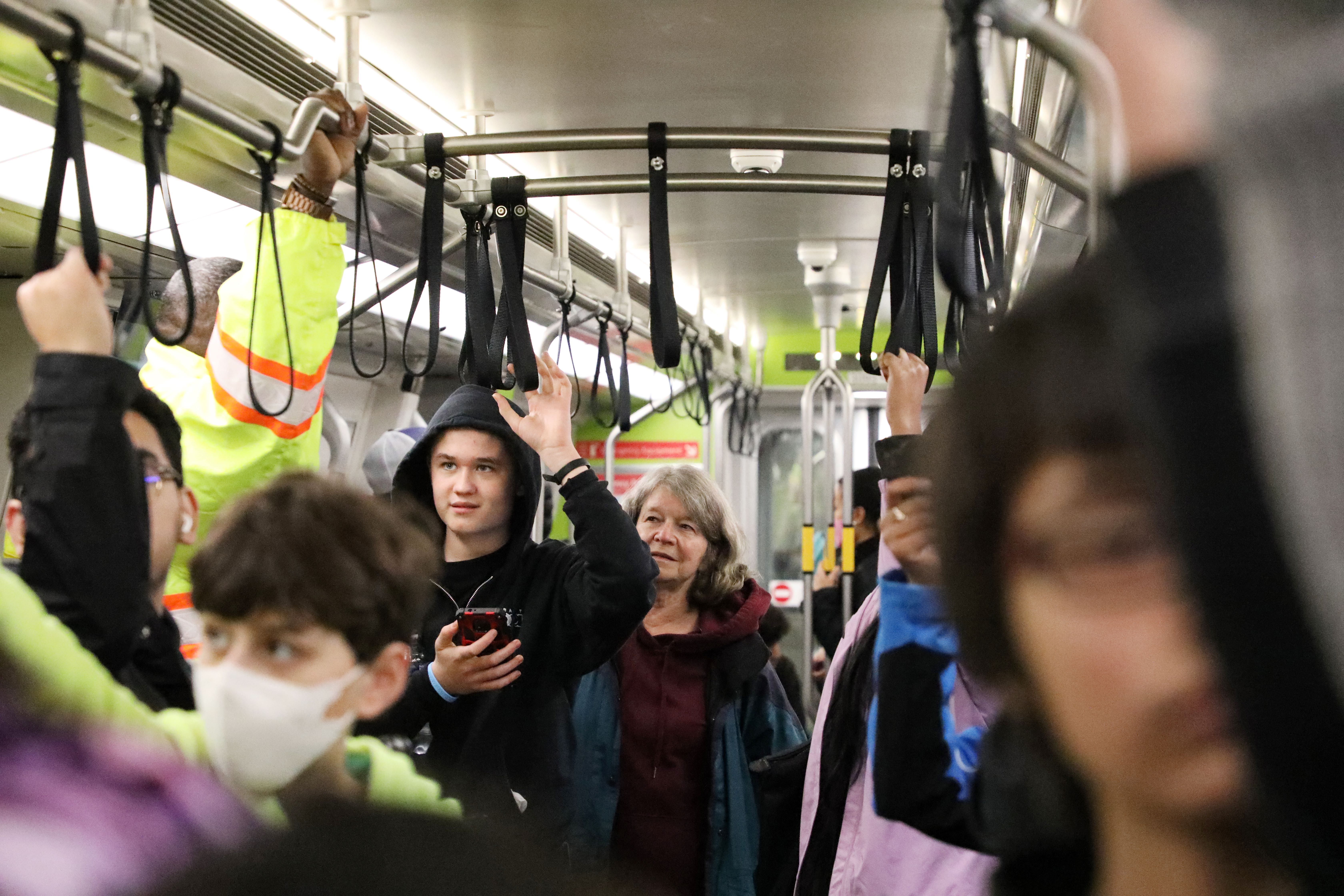 Local children ride BART between 19th St Oakland Station and Coliseum Station