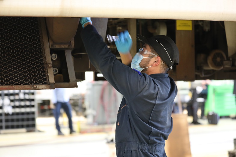 A worker prepares the last C2 car for decommissioning at Hayward Shop in August 2021