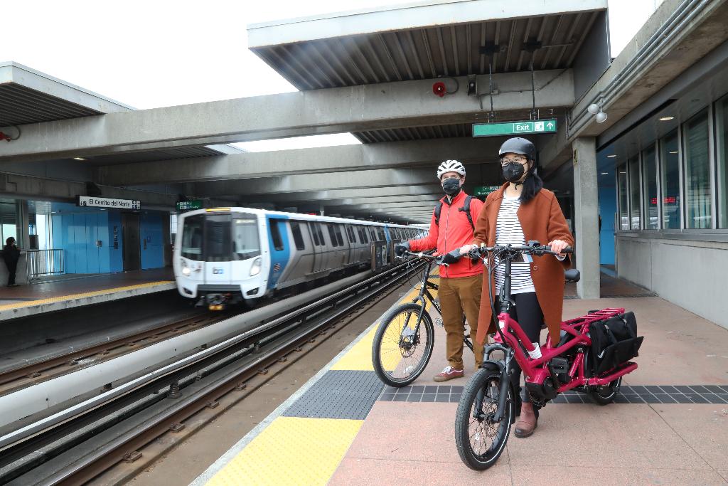Two BART riders with cargo bikes