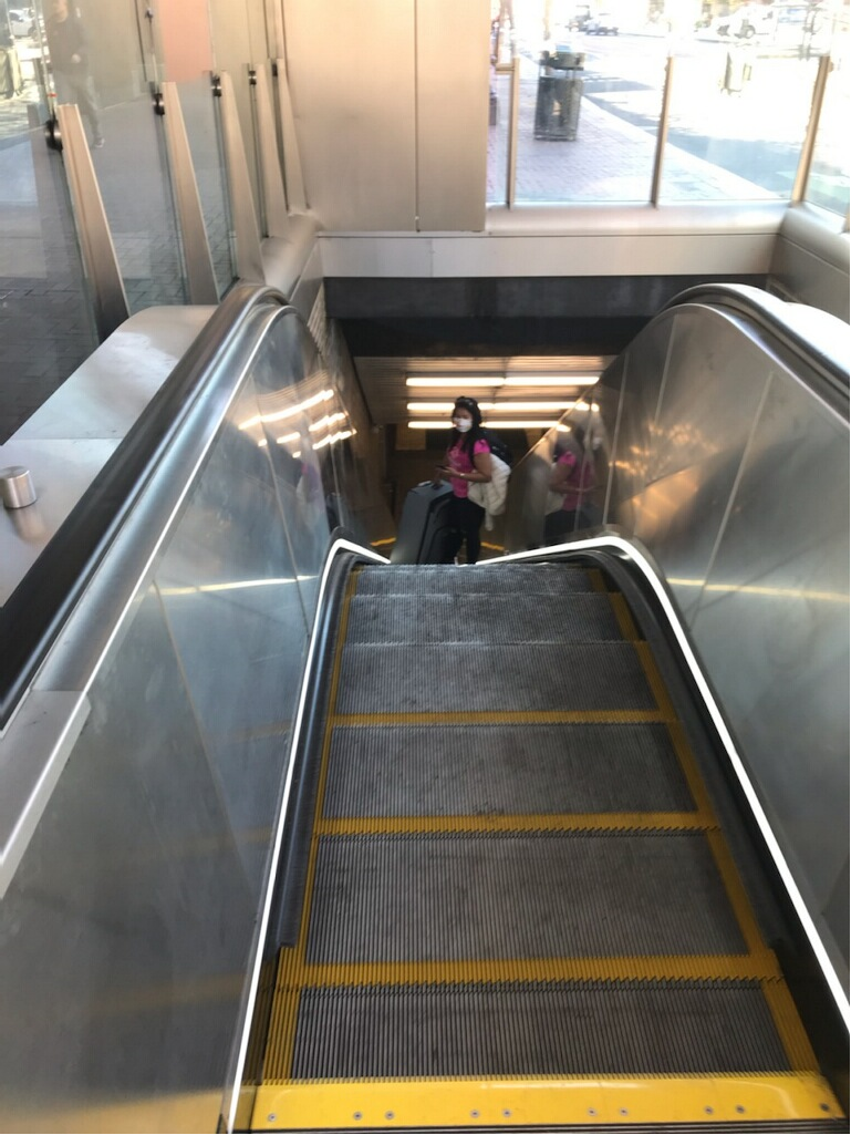 A passenger rides the rebuilt Civic Center Station escalator