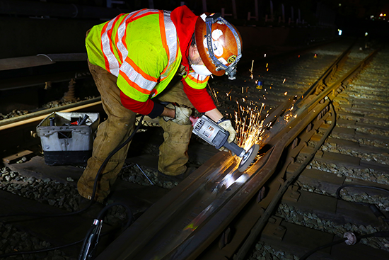 Grinding the rail in preparation for welding