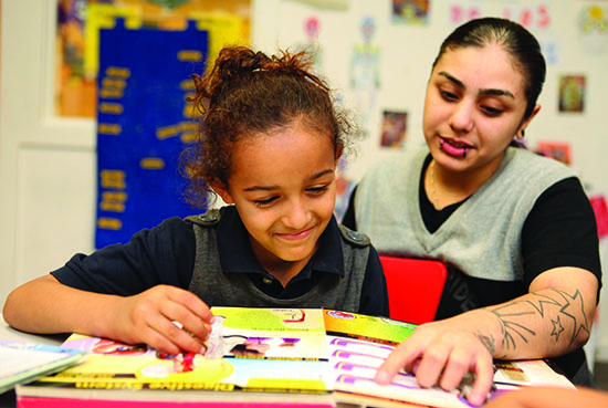 TNDC's Catalina Ortega helps a child