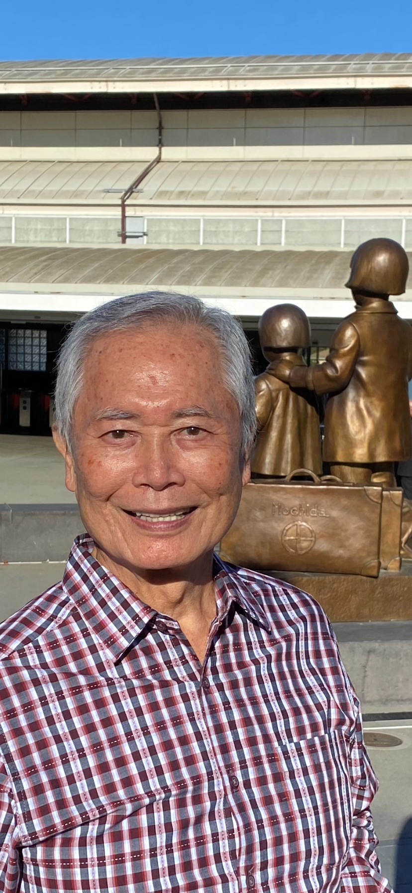 George Takei with Mochida sisters statue in background