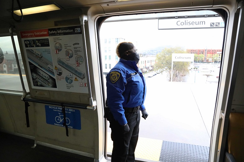Ambassador Sequoia Taylor checks the platform during a stop at Coliseum Station