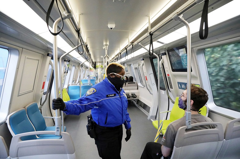 Ambassador Sequoia Taylor talks with a customer on a train 