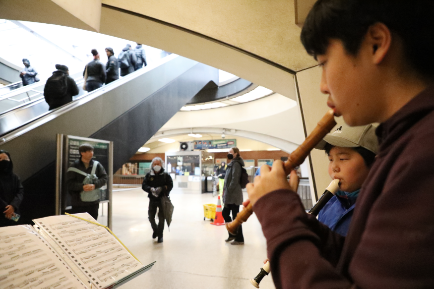 Brothers Lucas and Bryan Bai play Bach on their recorders as part of Bach in the Subways at Downtown Berkeley Station on March 2