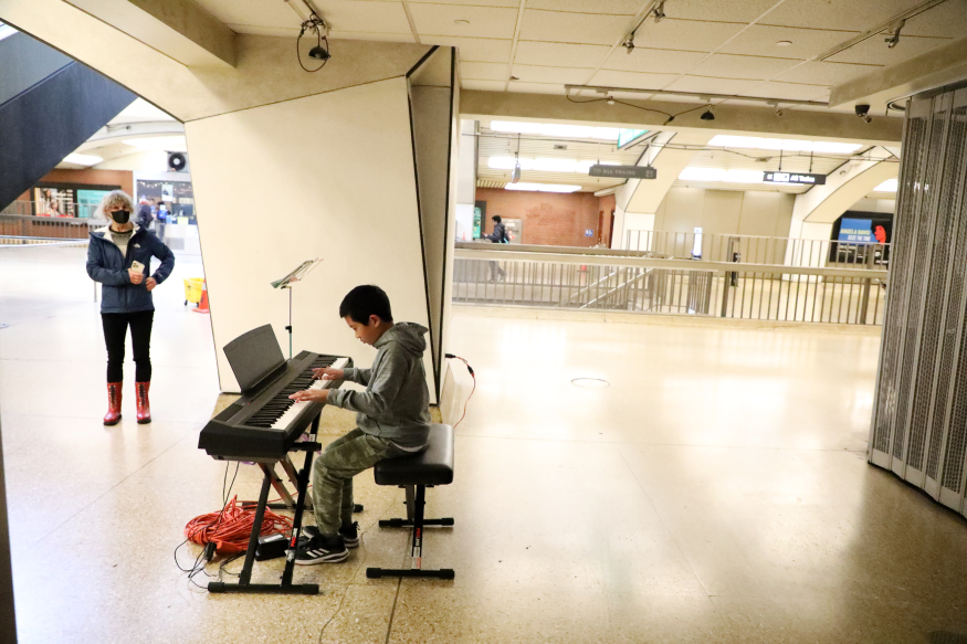 Jaylen Wei plays electric piano while performing for Bach in the Subways at Downtown Berkeley Station on March 21, 2023.