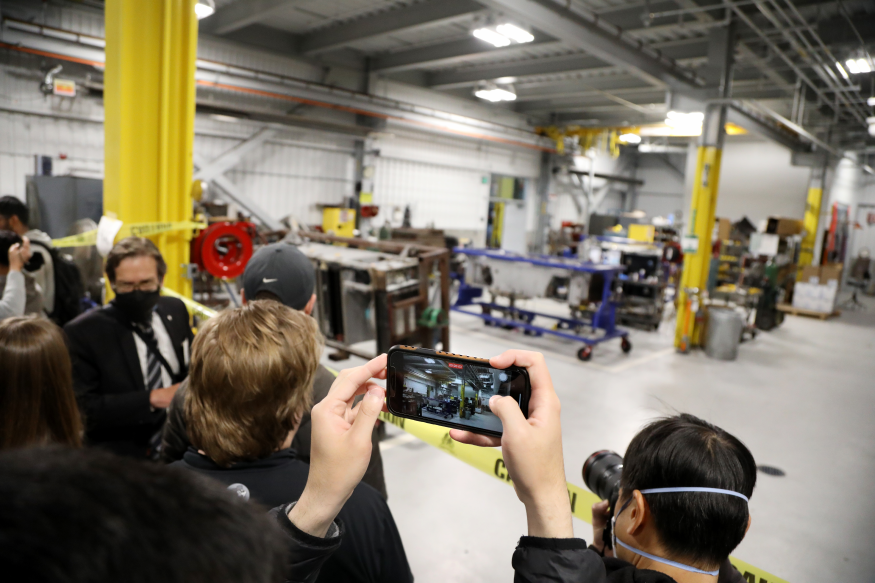 People point their cameras in the Hayward Maintenance Complex during a Board meeting and tour on Oct. 27.