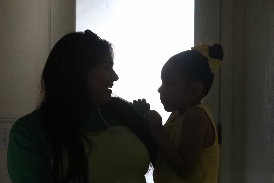 Michelle and her daughter in silhouette at Ursula Sherman Village in Berkeley. 