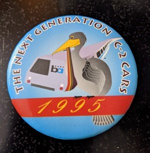 Promotional button issued for next generation C2 cars in 1995; appears to be a stork “delivering” the new baby 