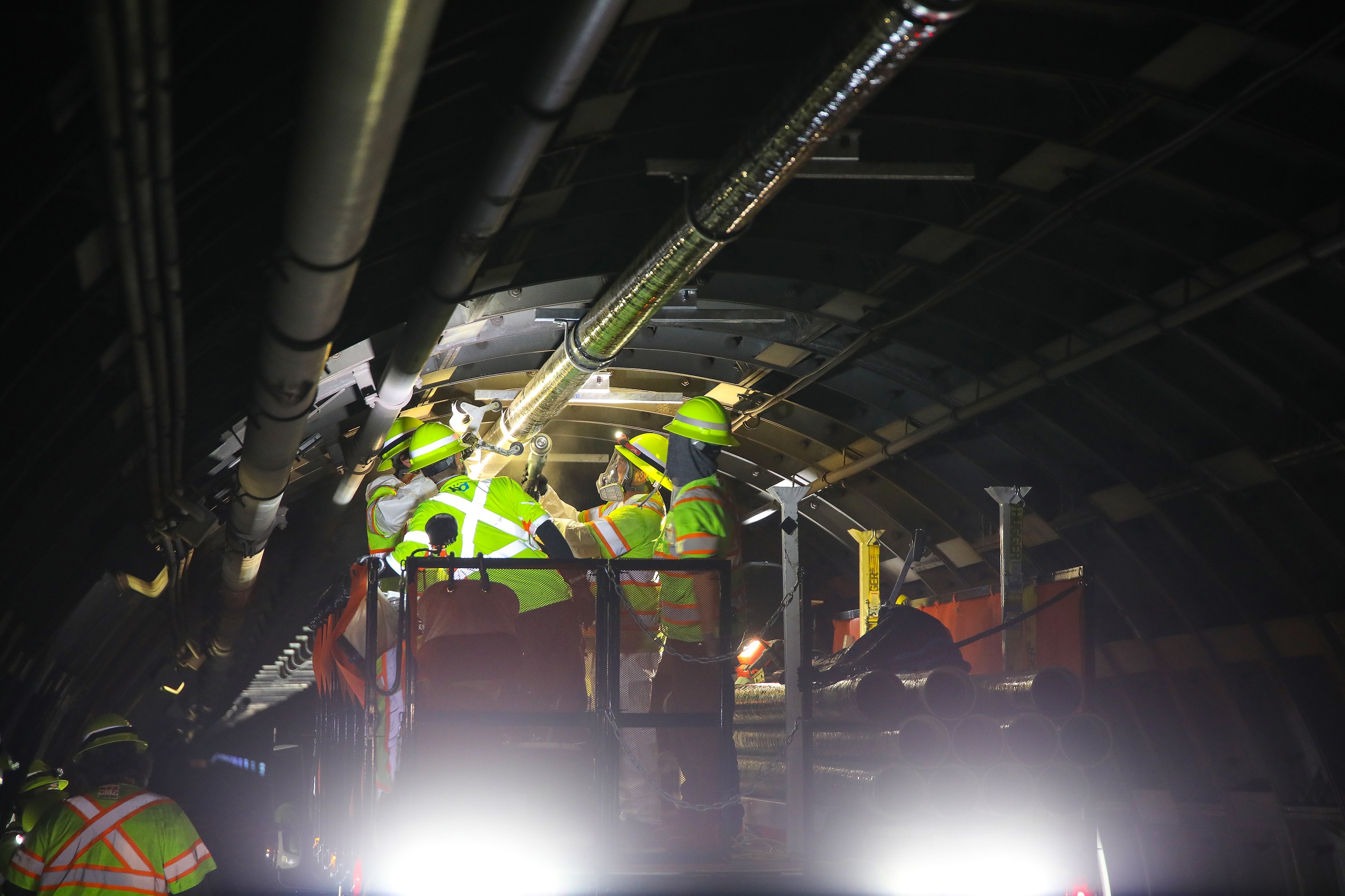 crews replacing cables in tunnel