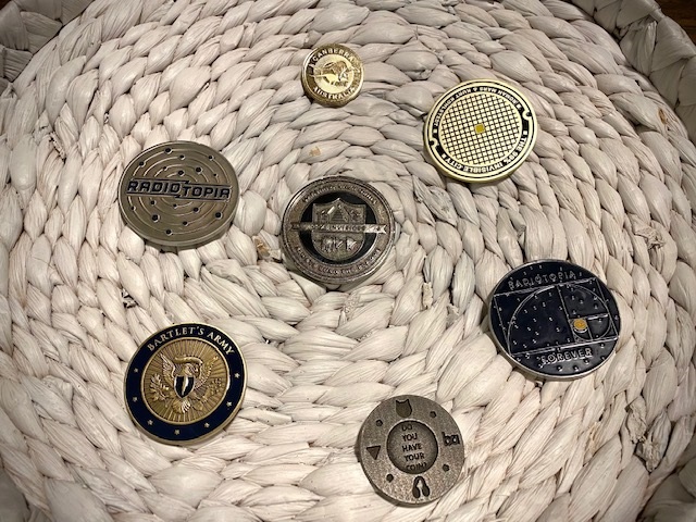 Some of the couple’s challenge coins: At center, the one Samii had in his pocket on the day they met; small gray coin at bottom 