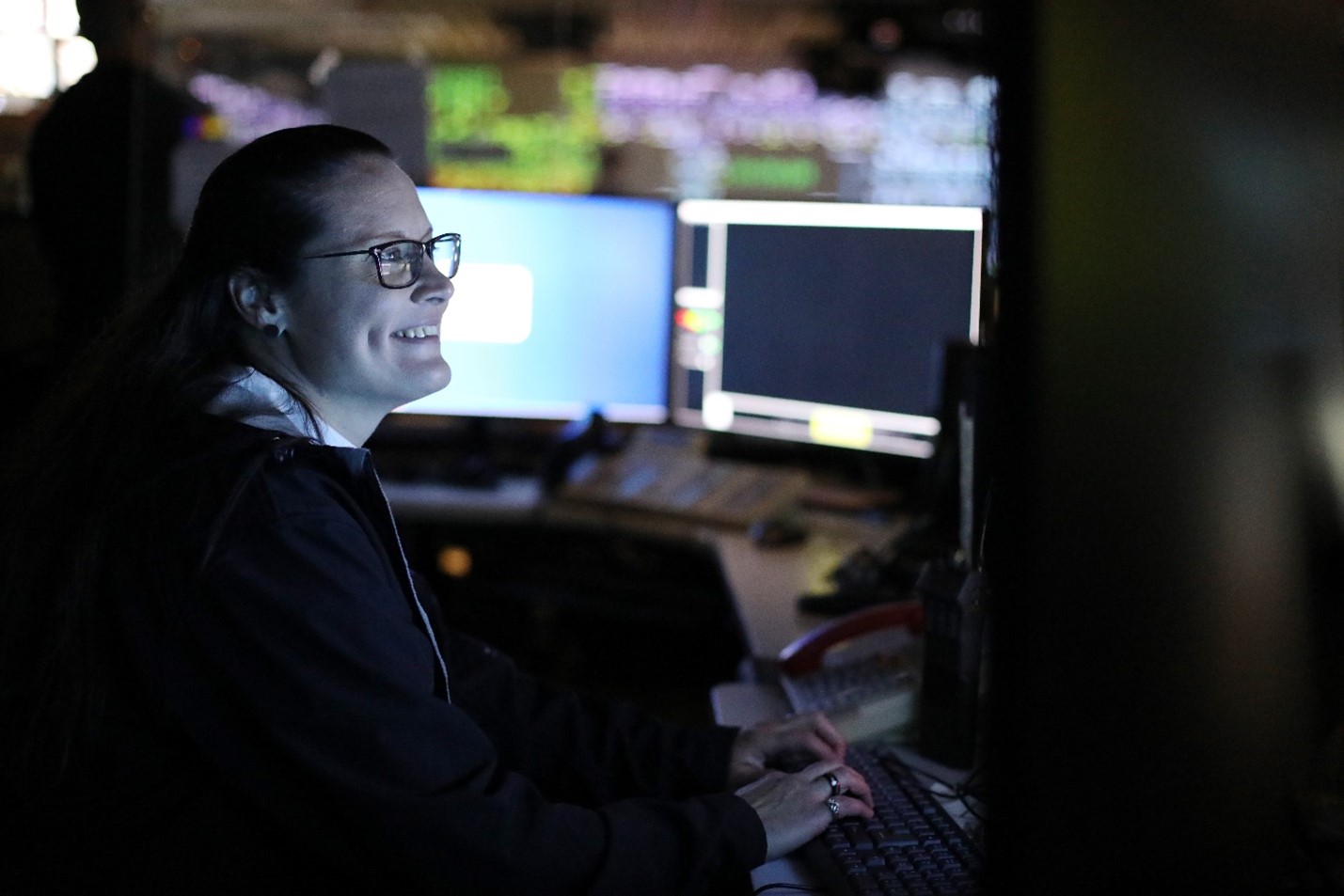 Rail Operations Controller Heather Dinsdale smiles at her desk.