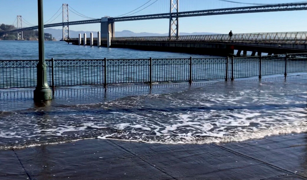 water spilling over into Embarcadero during high tide