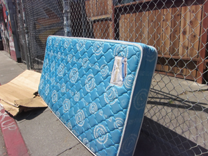 mattress lying by street