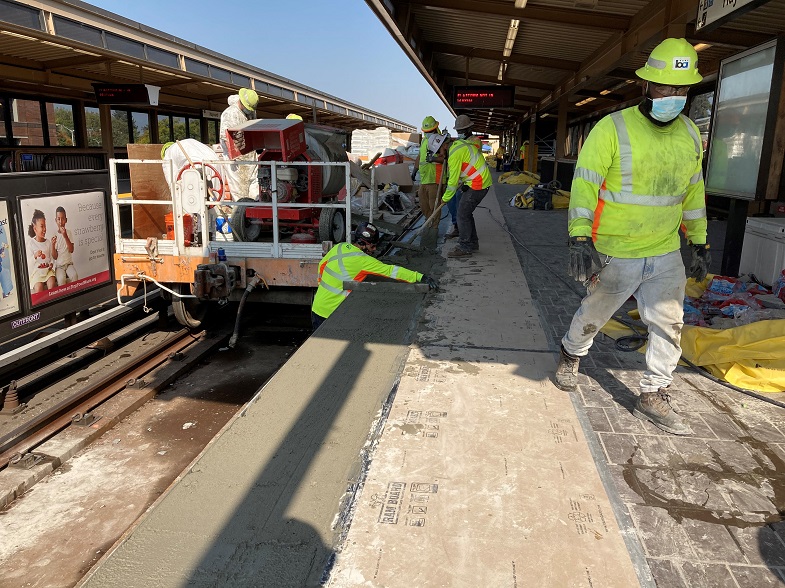 Workers leveling mortar bed for truncated dome tiles to be placed. Photo by Travis Huang