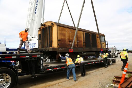 Workers loading up old grinder