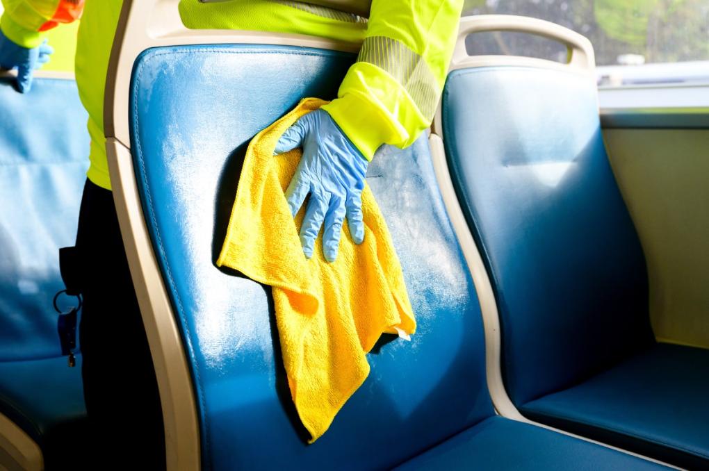 A seat is dried after being scrubbed with disinfectant soap and hot water during a thorough clean.  