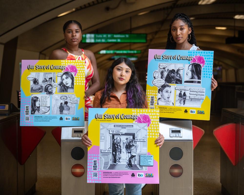 Some of the leaders of Not One More Girl Phase II pose with the project’s new art posters (Art by Safi Kolozvari Regalado). From left to right: Malkia Chionesu, development and purpose alignment consulting with M.CHIO; Gaby Guzman, Latinx Mentoring and Achievement Coordinator of Youth Services with The Unity Council; and Franchesca Rodriguez, Betti Ono Transit Justice Community Engagement Facilitator and graduate student at UC Berkeley’s Department of City & Regional Planning. 