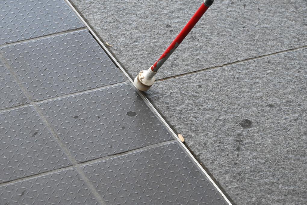 BART intern Erik Huizar’s cane studying the metal ridge of the tactile guideway at Union City Station on Wednesday, Sept. 6, 2023.