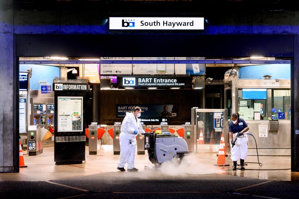 Michelle Slade (left) and Maria Chappell (right) hard at work scrubbing and power washing the entrance of South Hayward Station during an overnight deep clean. Each BART station is deep cleaned every few months.  