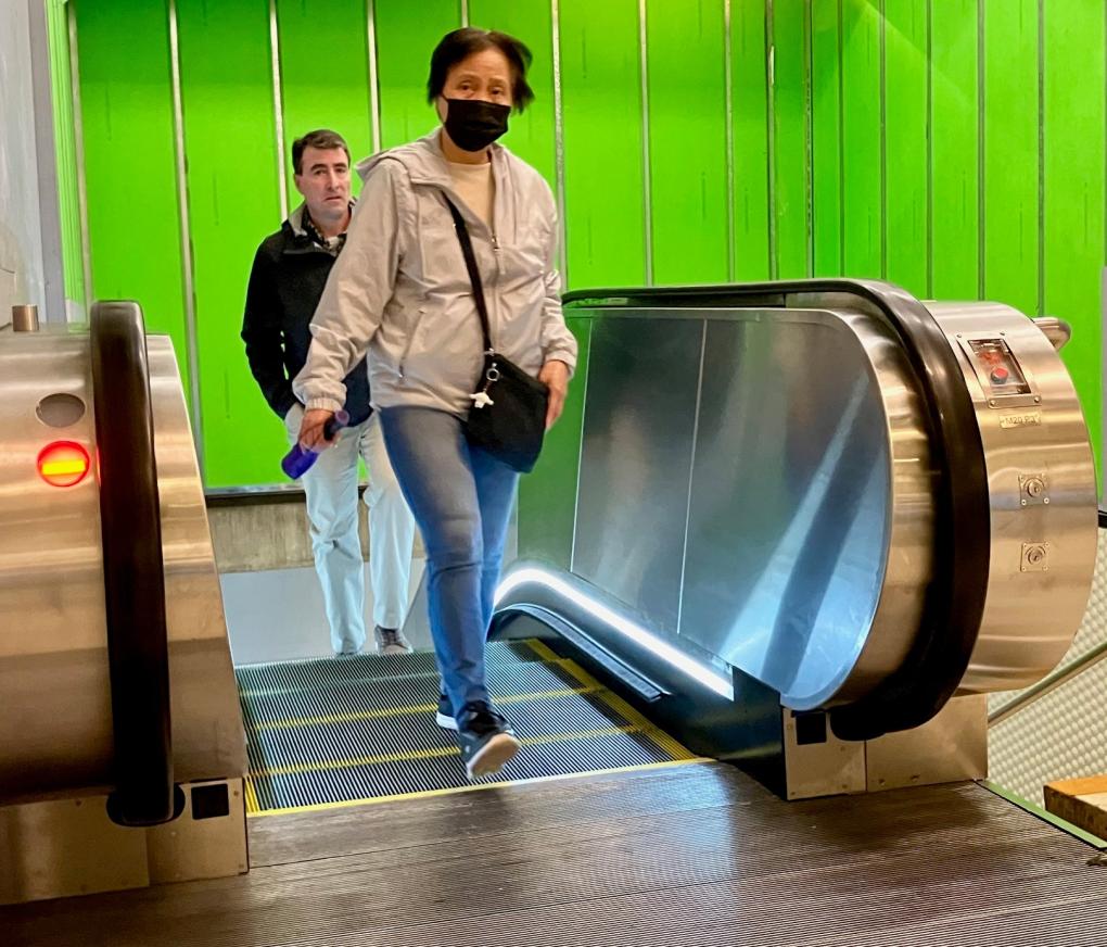 Riders on newly rebuilt escalator at Montgomery Street Station