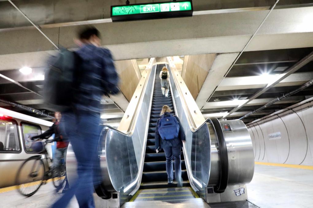 Riders on newly rebuilt escalator at Embarcadero Station