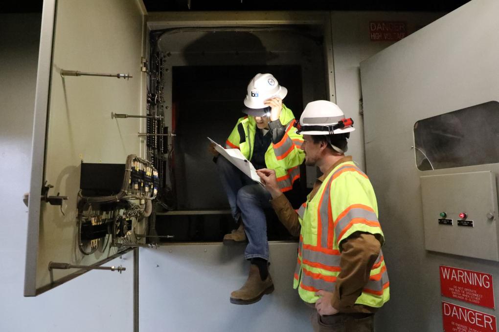 Two BART employees looking at a clipboard