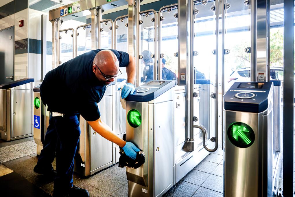 The new fare gates being cleaned by a system service worker