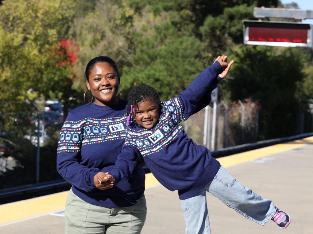 People wearing bart holiday sweaters on platform