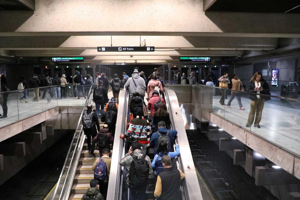 People on an escalator at Embarcadero Station