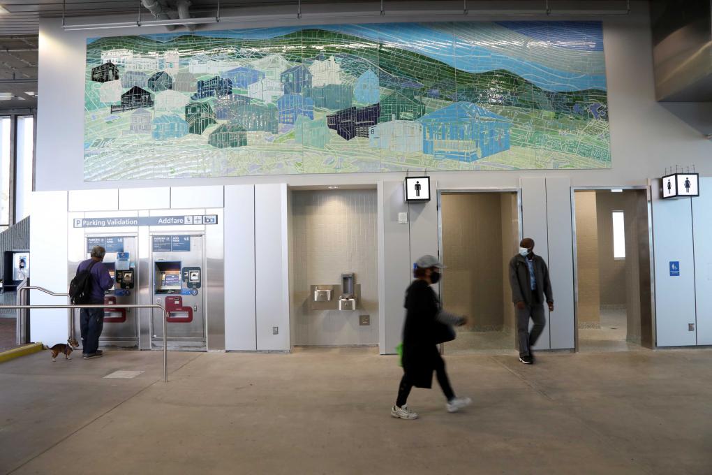Photo of upgraded concourse with mural, bathrooms, and Clipper machines​