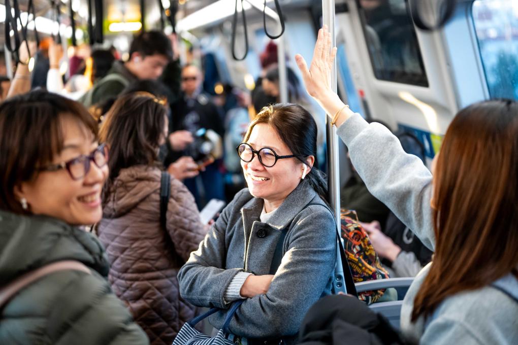 People on a train smiling
