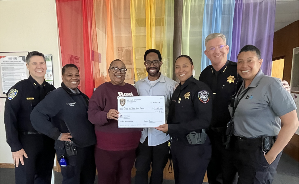Pictured at Side by Side in Hayward (l to r): BART Police Deputy Alan Love, Crisis Intervention Specialist Yolanda Barbosa, Side by Side Program Director Myeeka Calhoun, Side by Side Regional Director Larry Woodland, BART Police Officer Shanna Holmes, BART Police Chief Kevin Franklin, and Crisis Intervention Specialist Stephine Barnes. 